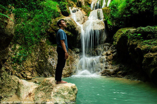 Young man enjoys the waterfall Mudal Picture Board by Hanif Setiawan