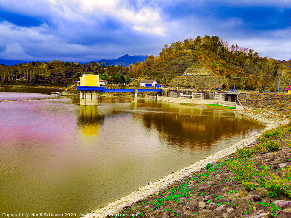 Water reservoir lake with hill, house and blue sky Picture Board by Hanif Setiawan