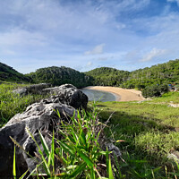 Buy canvas prints of Lagoon sand beach Kasap with green hills. by Hanif Setiawan