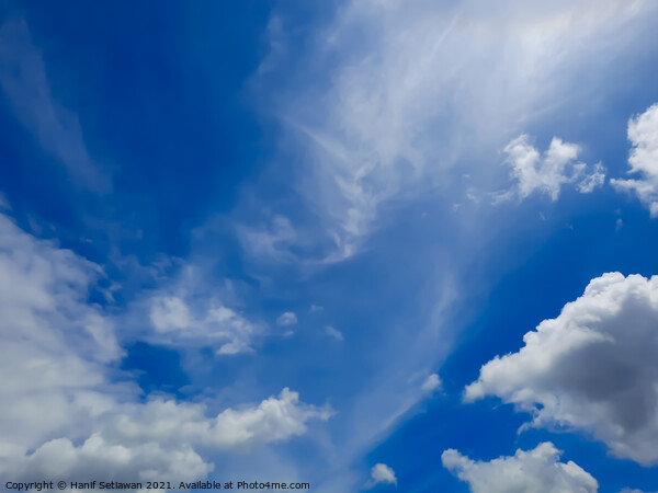 Fluffy white cloud shapes at blue sky. Picture Board by Hanif Setiawan