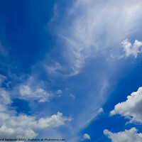 Buy canvas prints of Fluffy white cloud shapes at blue sky. by Hanif Setiawan
