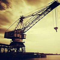 Buy canvas prints of A old crane next to the docks  by Paddy 