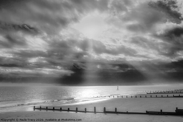 Sun rays streaming through clouds at Frinton beach Picture Board by Paula Tracy