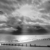 Buy canvas prints of Sun rays streaming through clouds at Frinton beach by Paula Tracy