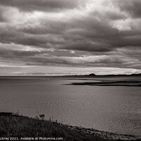 Buy canvas prints of Bamburgh Castle from Holy Island by Roger Aubrey