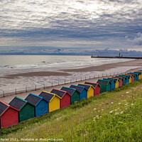 Buy canvas prints of Whitby Beach huts waiting for the storm by Richard Perks