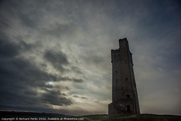Majestic Castle Hill Tower Amidst Rolling Clouds Picture Board by Richard Perks