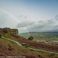 Buy canvas prints of Rainbow over the Cow and Calf, Ilkley Moor by Richard Perks