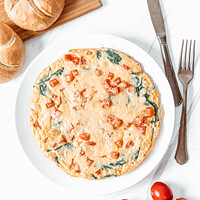 Buy canvas prints of Egg Omelette With Spinach, Tomatoes and Orange Pepper by Radu Bercan