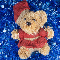 Buy canvas prints of Teddy bear on blue tinsel by aurélie le moigne
