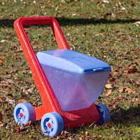 Buy canvas prints of Red and blue wheelbarrow in plastic by aurélie le moigne