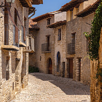 Buy canvas prints of Beautiful Cobbled Street in the Medieval Village of Mirambel, Teruel, Aragon, Spain by Pere Sanz