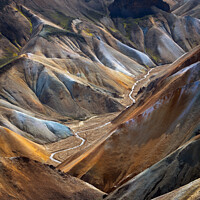 Buy canvas prints of River along a Valley in Landmannalaugar among colorful mountains, Iceland by Pere Sanz