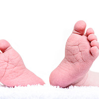 Buy canvas prints of Newborn feet close up on white background. Baby bo by Nicolas Boivin