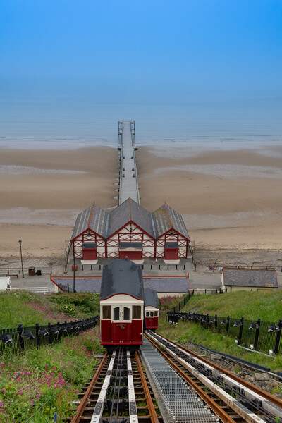 Saltburn cliff lift and pier on a summers day Picture Board by Kevin Winter