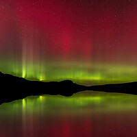 Buy canvas prints of The Northern Lights reflected in Loch Fada by Kevin Winter