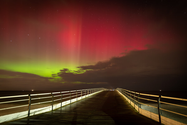 Aurora Borealis over Saltburn pier Picture Board by Kevin Winter