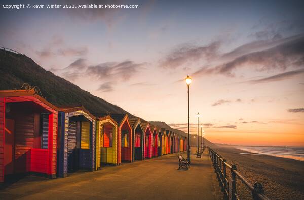 Beach Huts at sunset Picture Board by Kevin Winter