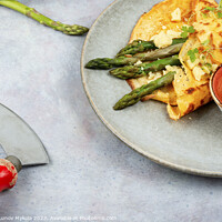 Buy canvas prints of Omelet with fresh asparagus and sauce. by Mykola Lunov Mykola