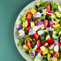 Buy canvas prints of Edible flowers vegan salad in a plate. by Mykola Lunov Mykola