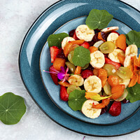 Buy canvas prints of Tasty fruit salad with nasturtium. by Mykola Lunov Mykola