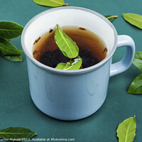 Buy canvas prints of Bay leaf herbal tea in mug by Mykola Lunov Mykola