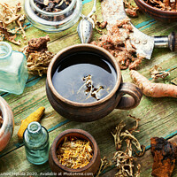 Buy canvas prints of Herbal tea on old wooden table by Mykola Lunov Mykola