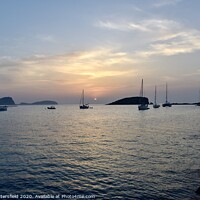 Buy canvas prints of Es Cana Ibiza sunrise just peaking through at 5.08 by Julie Tattersfield