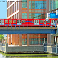Buy canvas prints of Docklands Light Railway train at Heron Quay by Laurence Tobin
