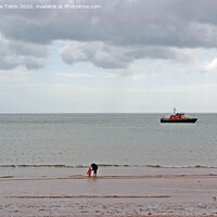 Buy canvas prints of Paddling at low tide near Clacton, Essex by Laurence Tobin