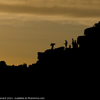 Buy canvas prints of Dusky sunset peak district scene. People line the top of stanage edge by Rhys Leonard