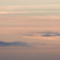 Buy canvas prints of Vertical hazy sunset. Horizon under warm and faded pastel colours. by Rhys Leonard