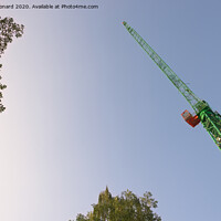 Buy canvas prints of Abstract looking up at the underside of a huge tower crane and trees by Rhys Leonard