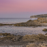 Buy canvas prints of Sunset on the rocky coast with anchored sailboat by Vicente Sargues