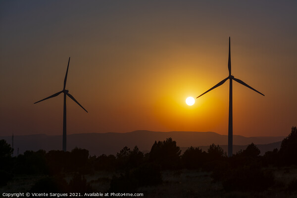 Two windmills facing the sun at sunset Picture Board by Vicente Sargues