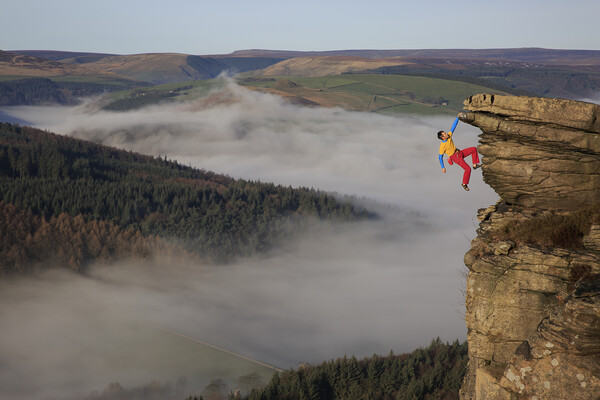A rock climber free climbing on bamford edge in th Picture Board by MIKE HUTTON