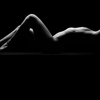 Buy canvas prints of a woman nude and naked in fine art photography bodyscape laying on black studio background by Alessandro Della Torre