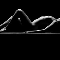 Buy canvas prints of a woman nude and naked in fine art photography bodyscape laying on black studio background by Alessandro Della Torre