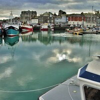 Buy canvas prints of Dark Skies & Reflections At Padstow, Cornwall. by Neil Mottershead