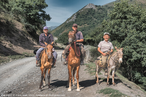 Three men riding horses and a donkey in Kyrgyzstan Picture Board by Frank Bach
