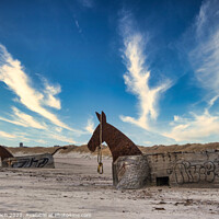 Buy canvas prints of Bunker mules statues on a Nortj Sea coast beach in Blaavand, Den by Frank Bach