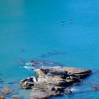 Buy canvas prints of Two paddle boarders on the cornish coastline in pe by Peter Barber