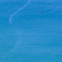 Buy canvas prints of A canoe on the clean blue water of Trebarwith Strand. by Peter Barber
