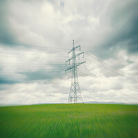 Buy canvas prints of High voltage power line in the green field in Germany in the center of a radial blur by Ingo Menhard