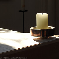 Buy canvas prints of A closeup shot of a candle in the candle holder on the white cloth under the sunbeams by Ingo Menhard