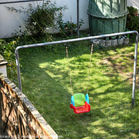 Buy canvas prints of Colorful child swing in a garden by Ingo Menhard