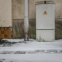 Buy canvas prints of Vertical of an electricity control box on the snowy road by Ingo Menhard