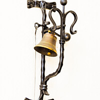 Buy canvas prints of A vertical shot of a bell hung on the forged metal isolated on white background by Ingo Menhard