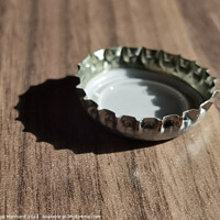 Buy canvas prints of A closeup shot of a bottle cap on a wooden surface by Ingo Menhard