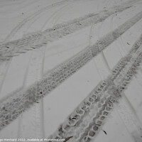 Buy canvas prints of Closeup of the tire marks on the snowy road by Ingo Menhard
